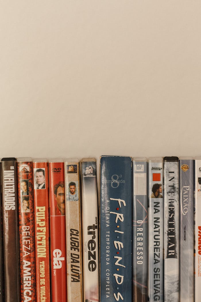 Vertical stack of DVD movie cases featuring various classic films in a minimalist setup.